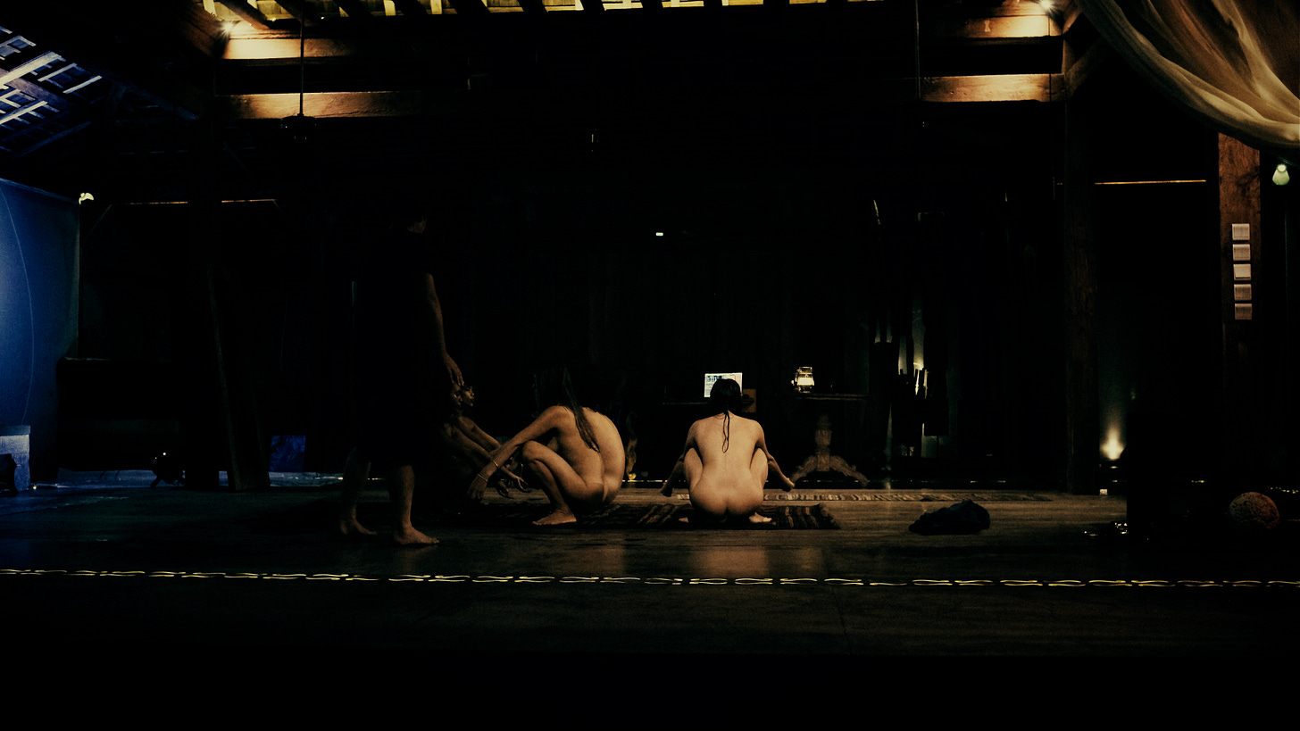 Couples practicing intimate tantric connection ritual by candlelight