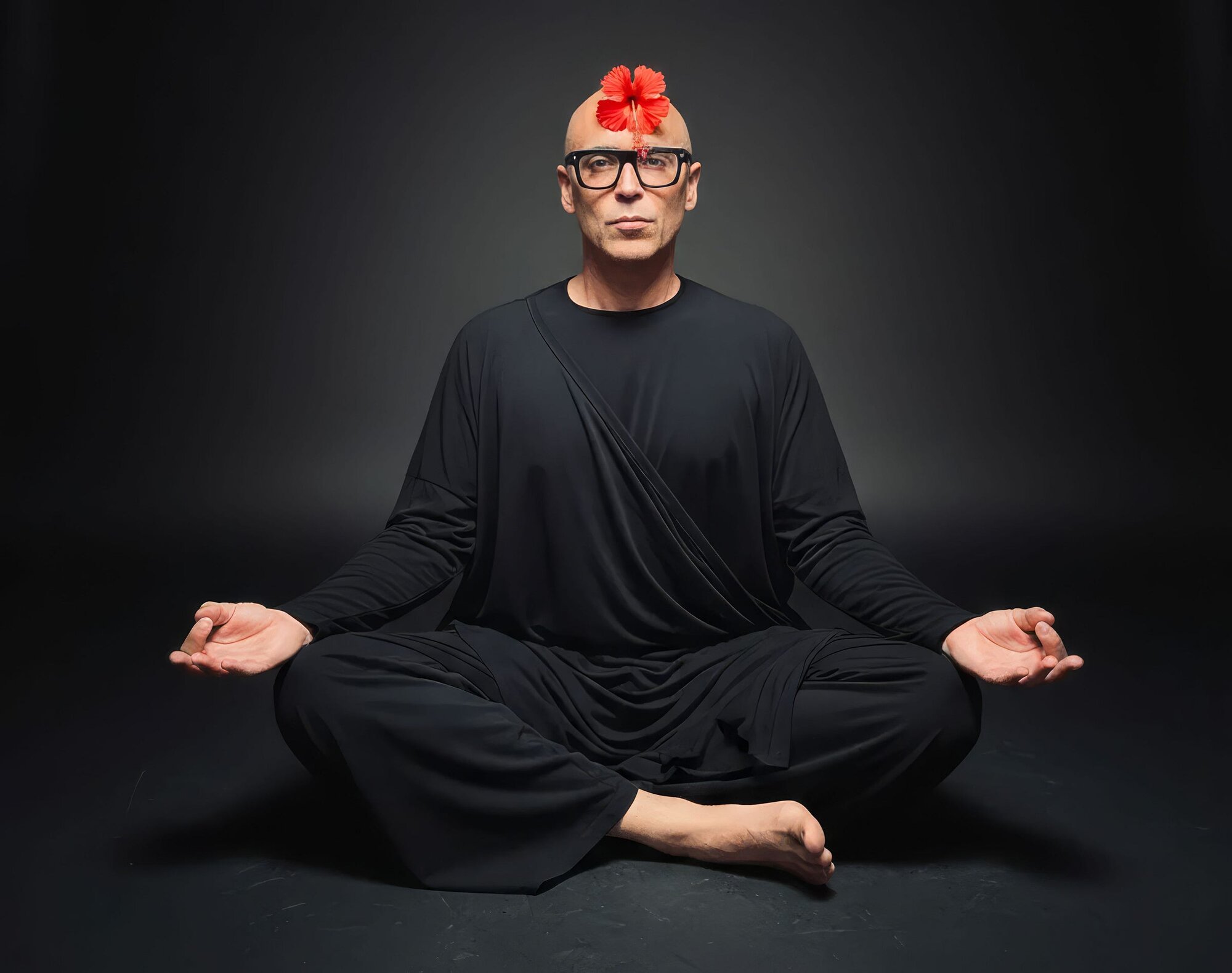 Spiritual teacher in lotus meditation pose demonstrating pranayama practice