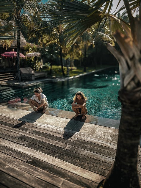 Yoga squat pose practice at tropical pool during retreat